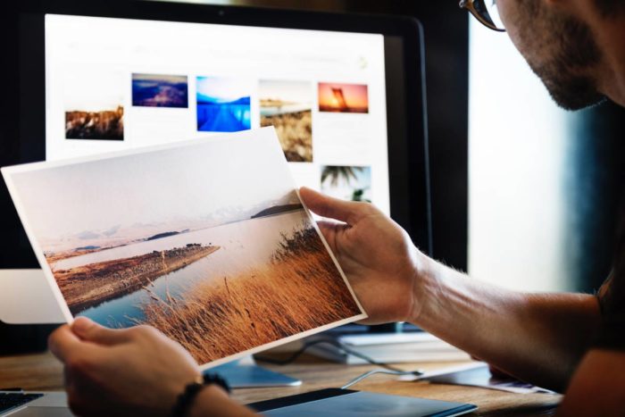 Man looking at photography print