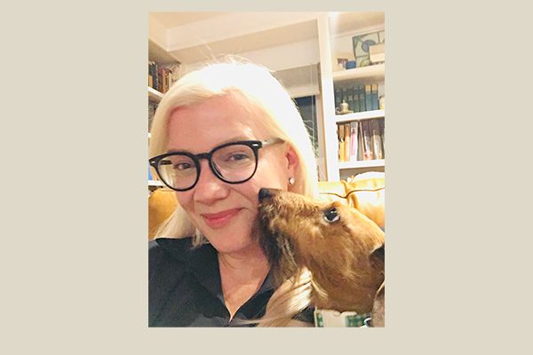 Photo of Krista Kane smiling with her dog