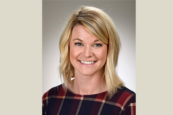Lacey Exton – 600×400 brown background Lacey Exton headshot