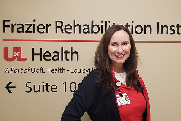 Rebecca McGuire – 600×400 Photo of Rebecca McGuire in front of Frazier Rehab wall signage